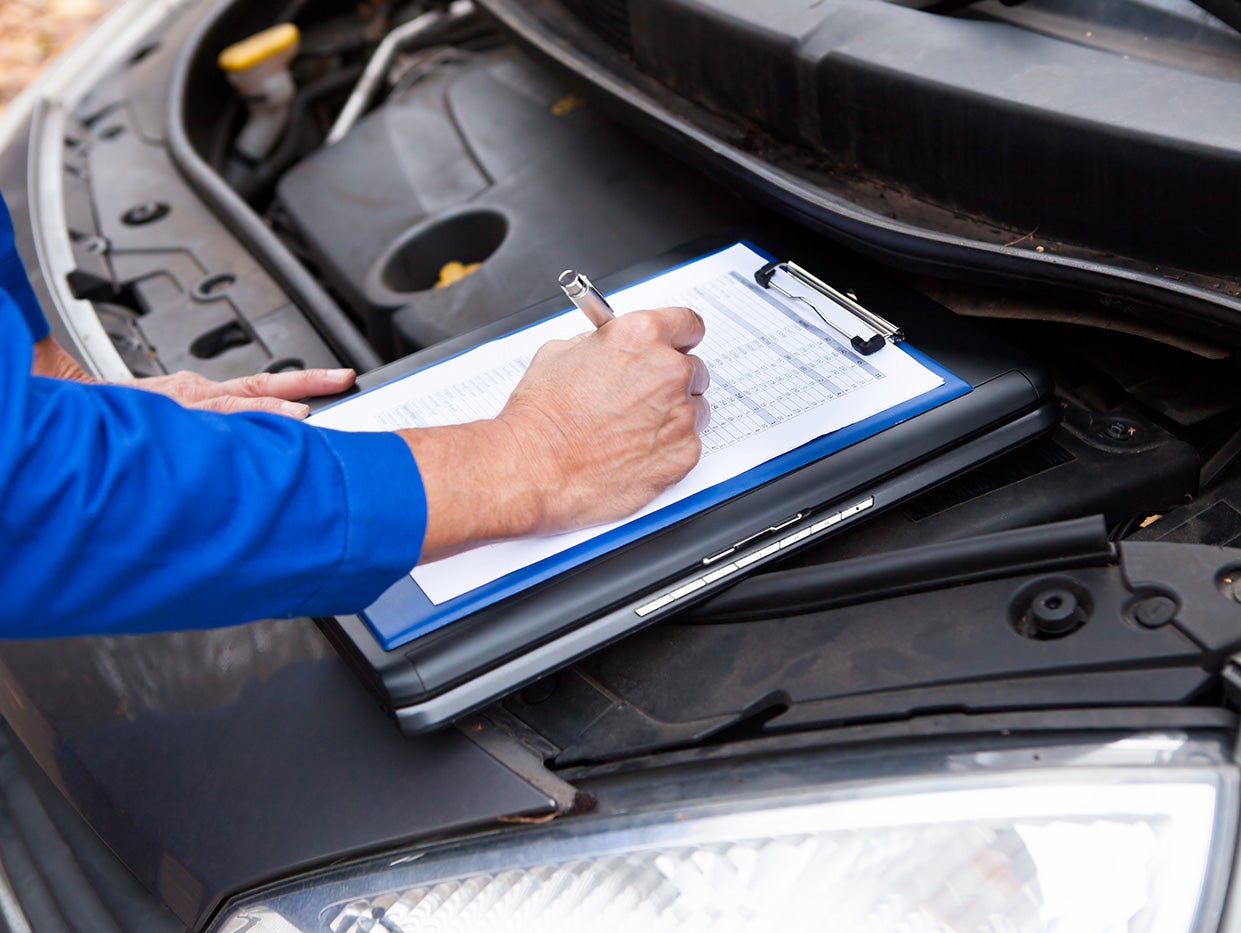 Mechanic Inspecting Vehicle